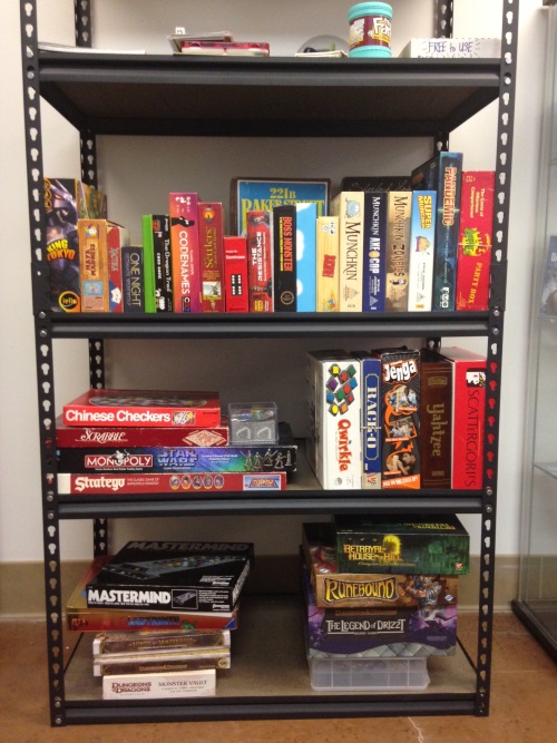 A growing shelf of free-to-play games; I've been slowly contributing to it as I've visited various thrift stores in the area: Qwirkle, Rack-O, Jenga, Maya Madness, Apples to Apples, Carcassone...