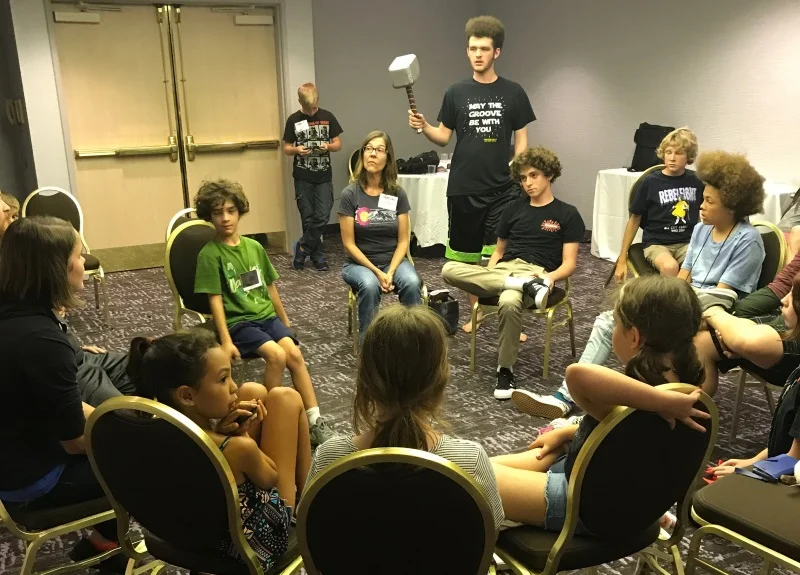 The kids (foreground) realizing Ann Marie was suspicious, and voting to take her out! (Yes, she was a werewolf.)