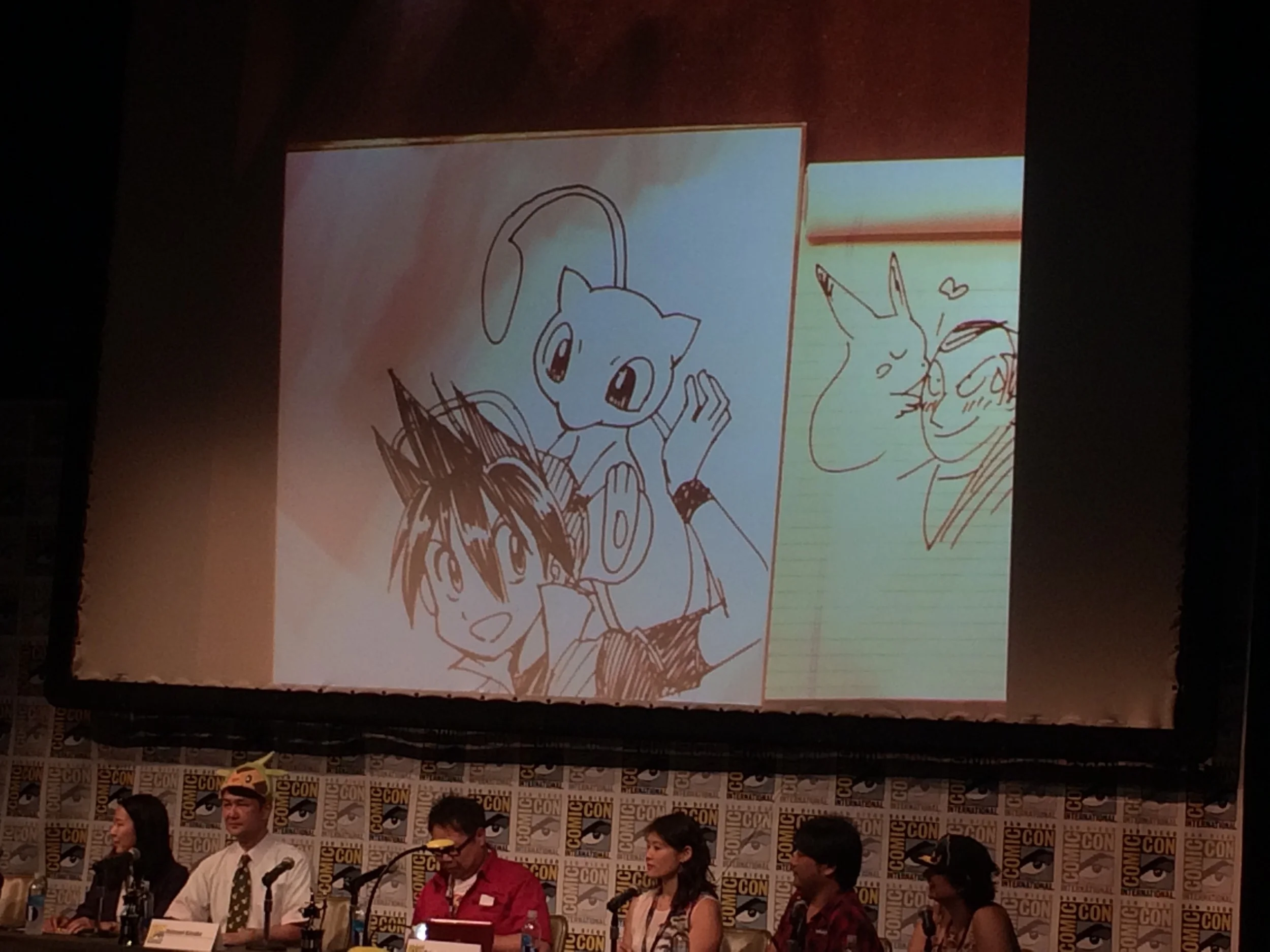 Unexpectedly, one of the great highlights of my SDCC experience was the Pokemon Adventures anniversary panel on Saturday morning. I went because I read the Pokemon Adventures manga as a kid. The writer and artist, as well as the Japanese and English editors, made up the panel. At one point, the audience voted on characters (Red, Sapphire, Giovanni, Black) and Pokemon (Pikachu, Greninja, Mew, Tyranitar) to appear in a picture together drawn by the artist live while other panel members answered questions. The audience choose Red and Mew. As the artist started to drew—and we watched his work on the big screen above—the writer commented that we made such a nice choice. Mew and Red were a perfect fit. Now, if we had chosen Giovanni and Picture, said the writer, he would have been concerned. As some of you might know, Giovanni is the evil boss of Team Rocket, and the worst members of Team Rocket, Jessie and James, are always trying to catch Pikachu. Anyway, as the writer made this observation, glowing with happiness, the artist pushed away his drawing and pulled over a legal pad, where he started to draw... Giovanni. Then Pikachu. Then Pikachu kissing Giovanni, and Giovanni blushing, and the audience roared with laughter, and then the writer finally caught on. They ended up giving both pictures away in an epic game of rock-paper-scissors with the audience. We all also got free posters. I don't even know what more to say. 