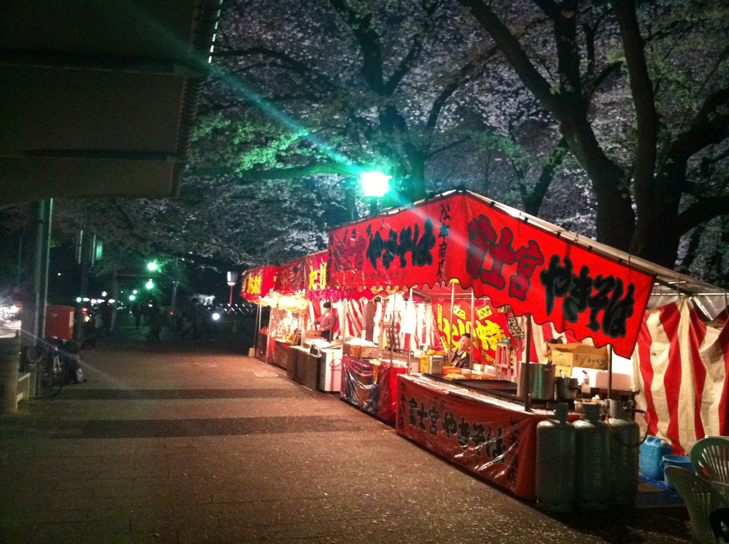 Left: A “light-up” at Nagoya Castle during cherry blossom season. Right: a food stall with cherry trees.