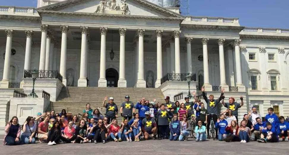 Bike away the bomb 'waves goodbye to nuclear weapons' with the ATOM Project and school-children from Kentucky, in front of the US Capitol Building in Washington DC