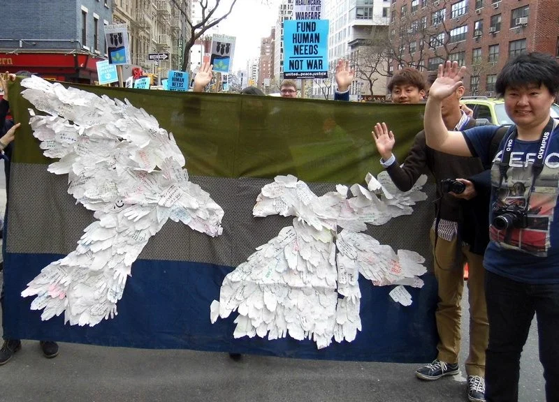 Peace& Planet Rally participants wave goodbye to nuclear weapons, Manhattan, NY.