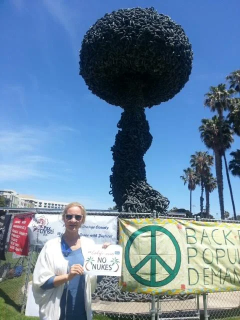 Joan Collins, Pacific LA Co-President of UNA-USA, waves goodbye to nuclear weapons at the Santa Monica Peace Rally.