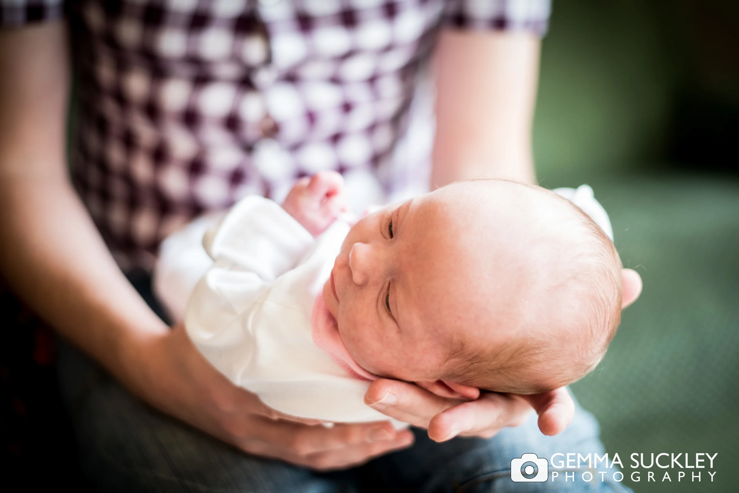 a father holding his baby's head
