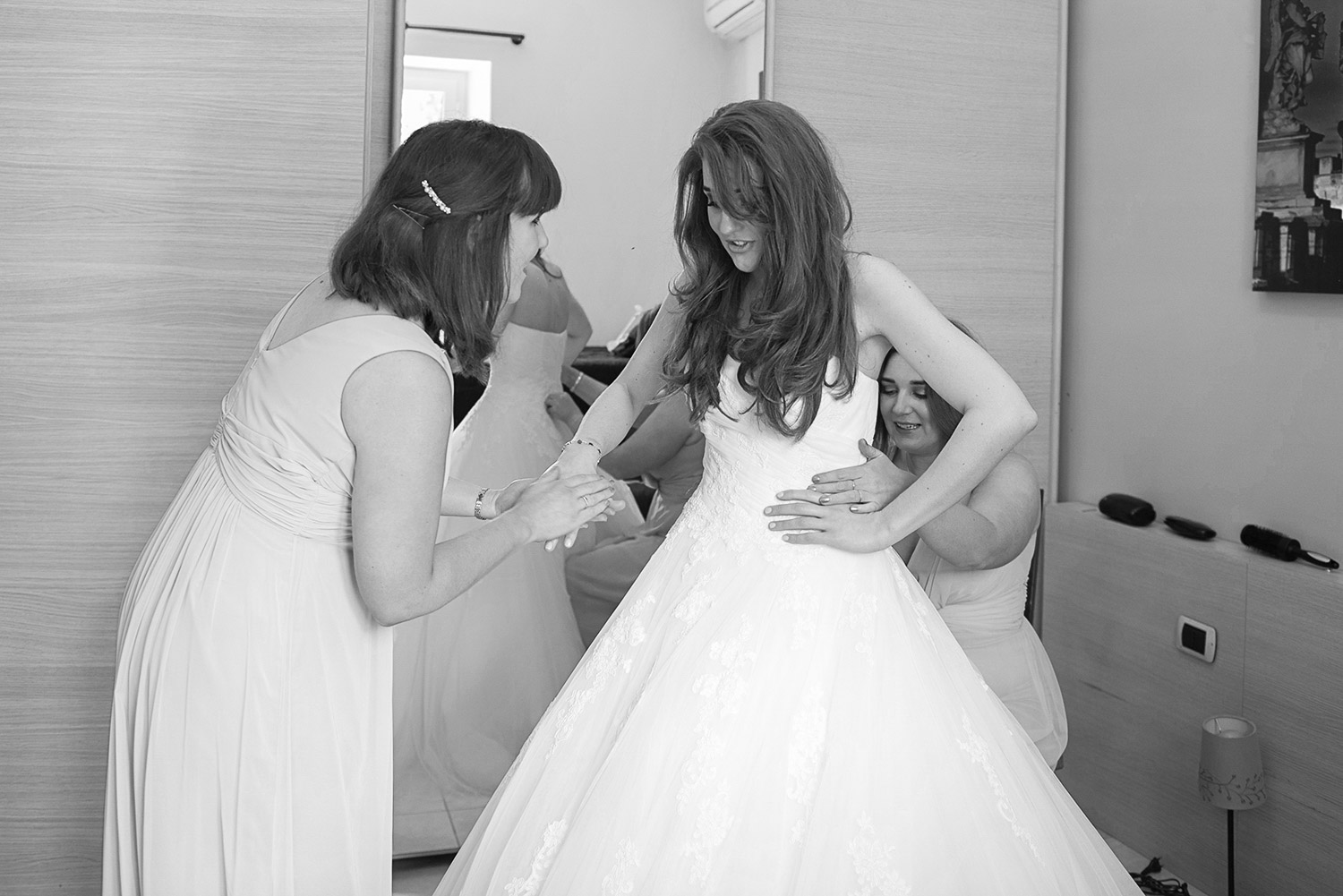 a bridesmaid calming the nervous bride at bridal preparation 
