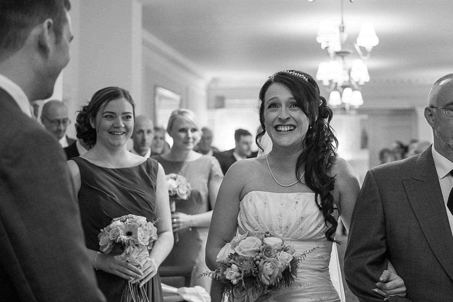 excited bride walking down the aisle at Hoyle Court in Baildon