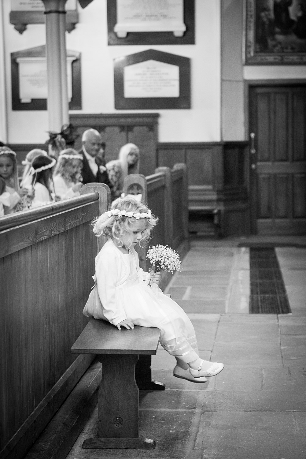 sulking flower girl at wedding ceremony 