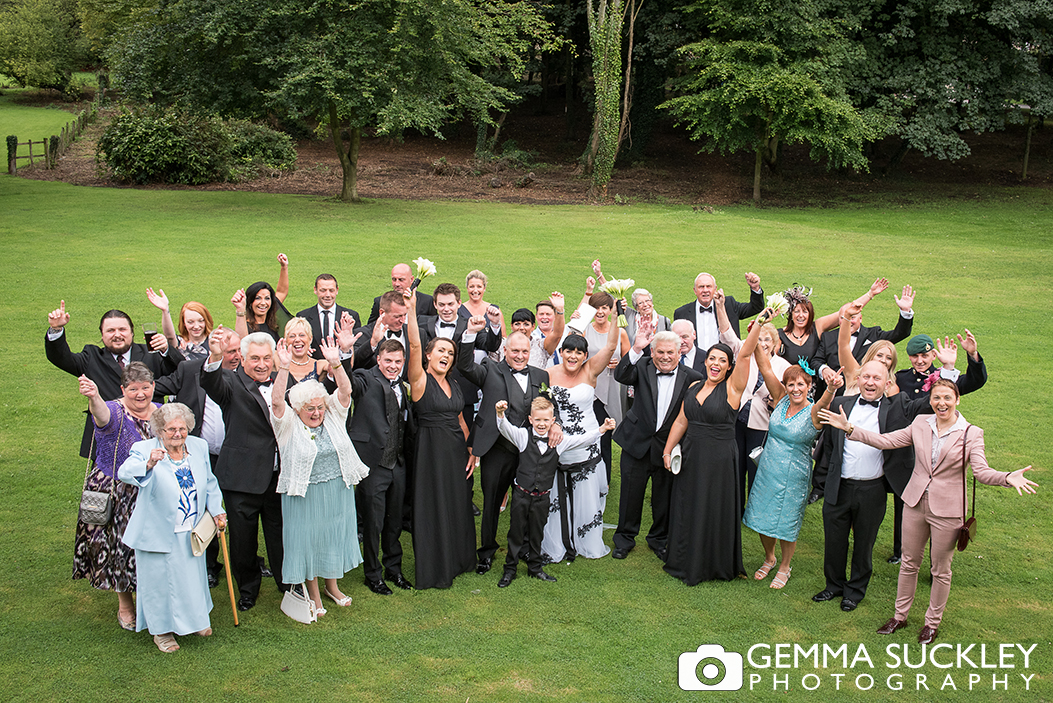 Group wedding photo in the gardens of Monk Fryston Hall