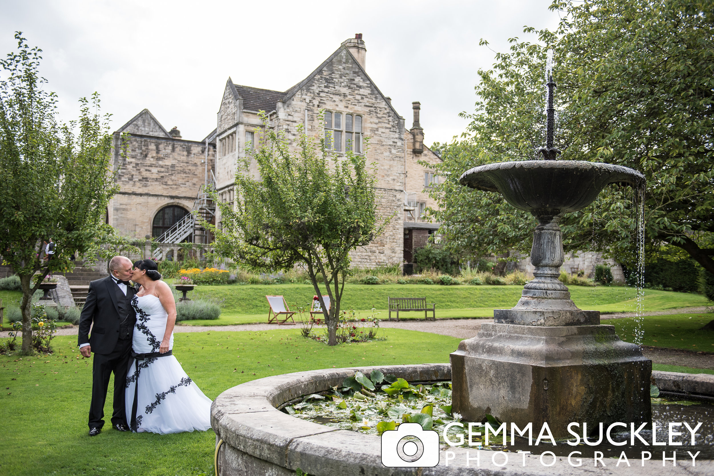 bride and groom kissing outside Monk Fyrston Hall on their wedding day