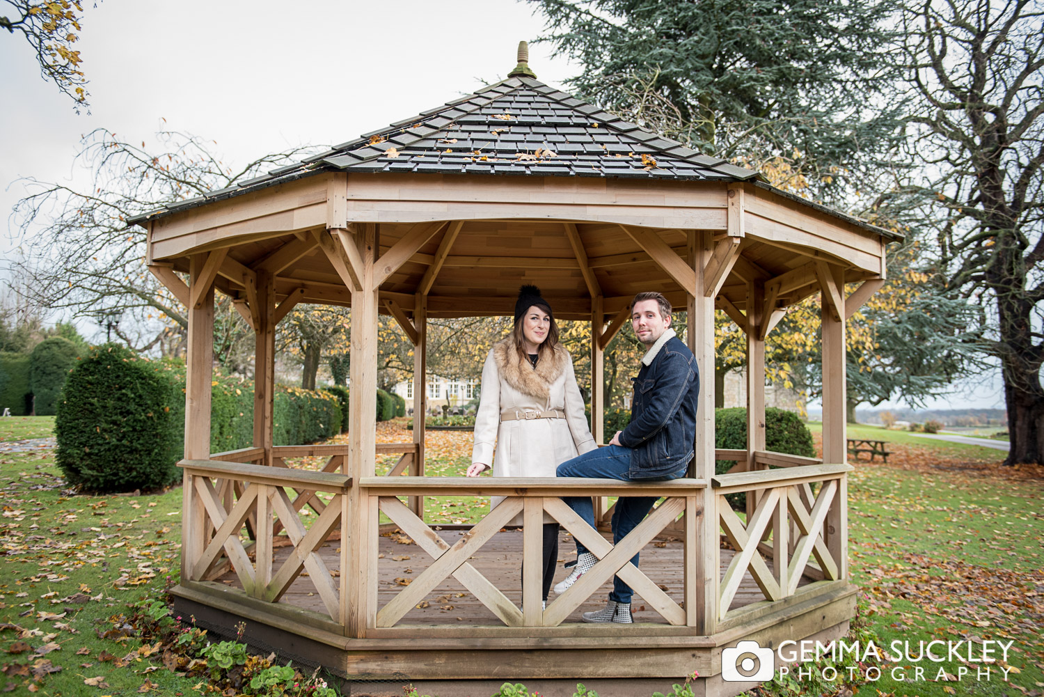 A couple smiling in a bandstand at Hazlewood castle