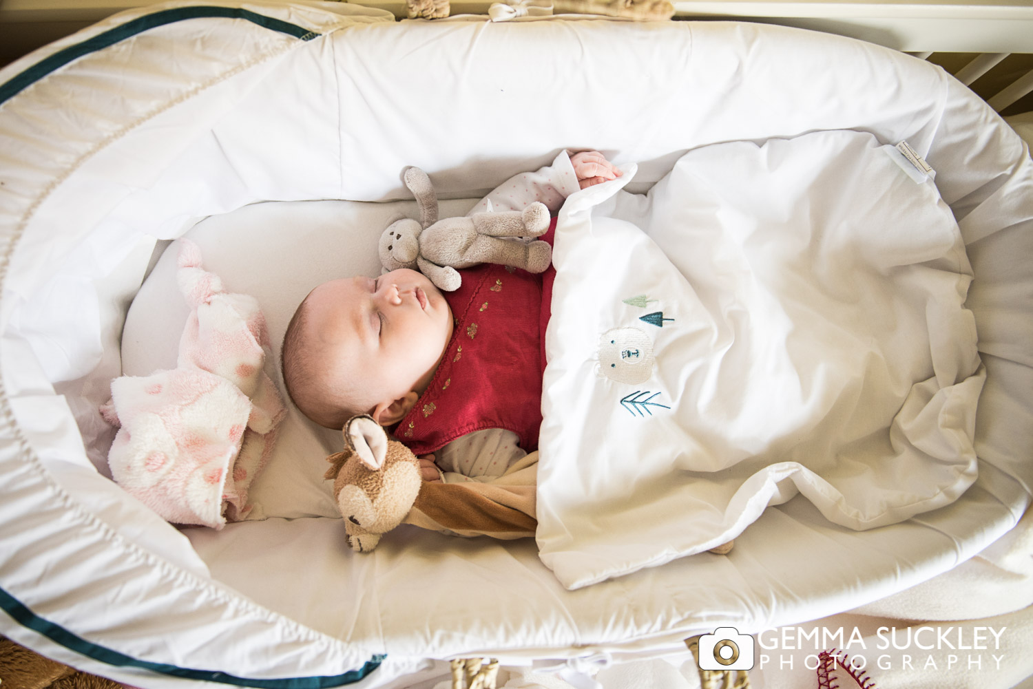 a newborn baby sleeping in her cot
