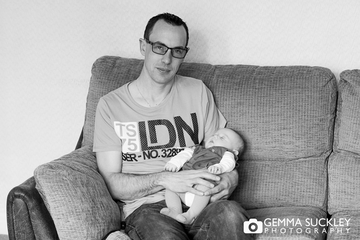 a dad holding his newborn baby