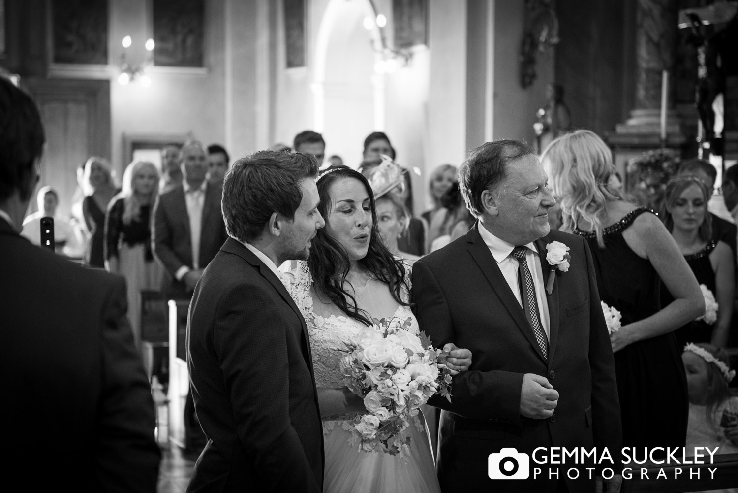 the bride signing in relief after walk down the aisle 