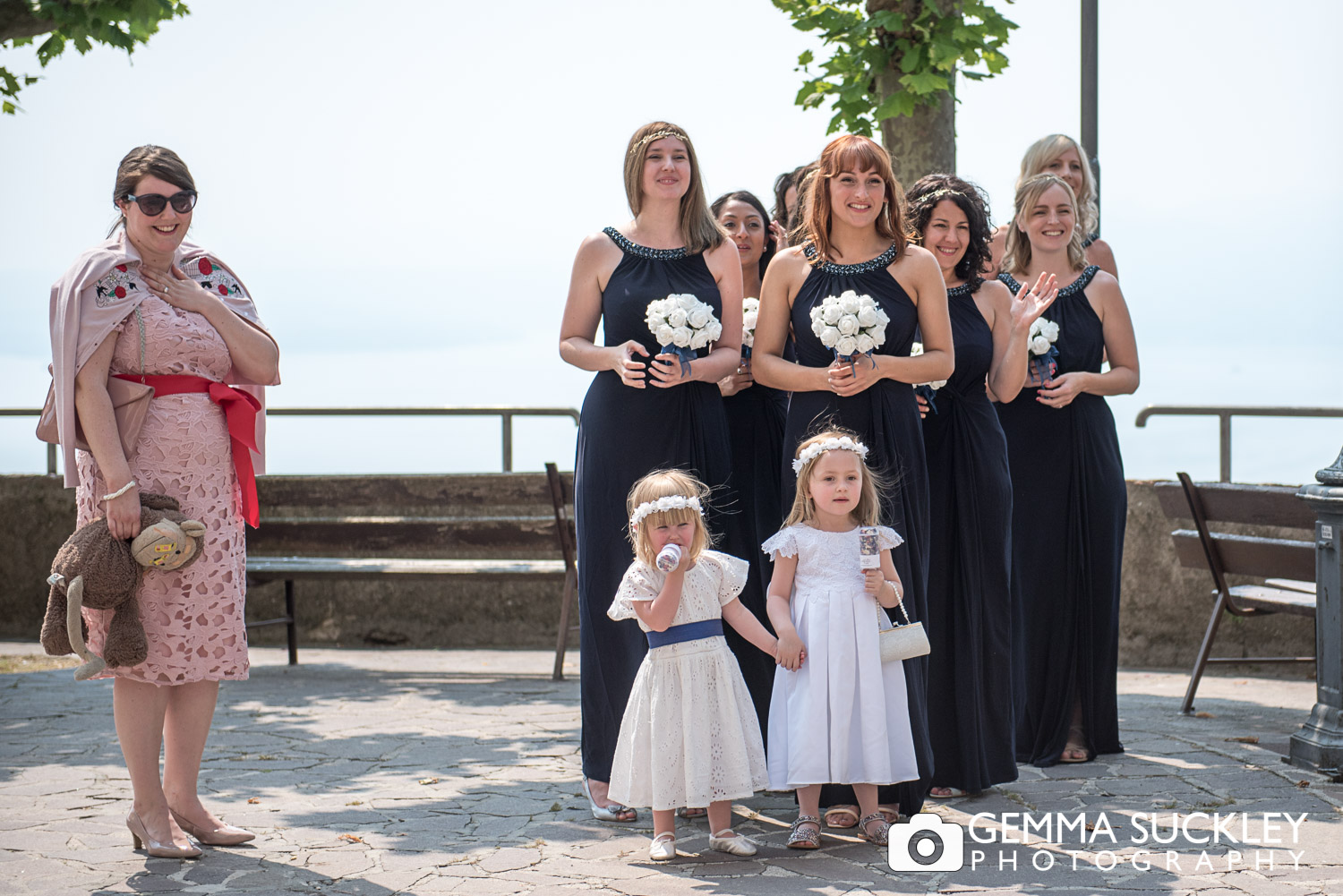 bridesmaid watching the bride arrive with lake Garda in view
