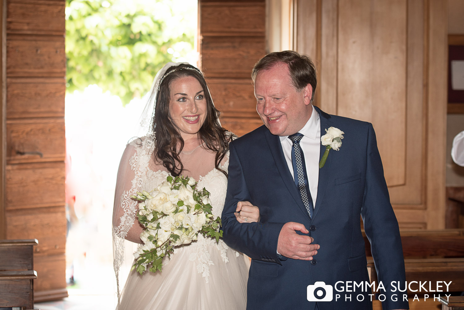 bride and bride's father walking down the aisle