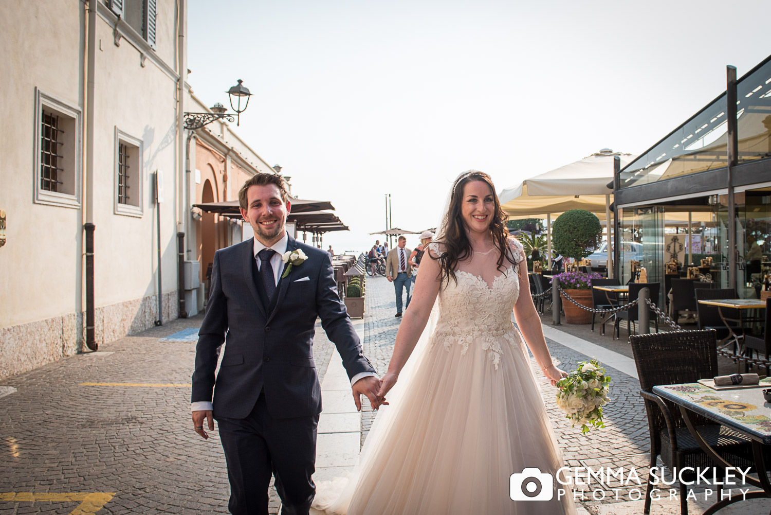 bride and groom walking in Bardolio, Lake Garda