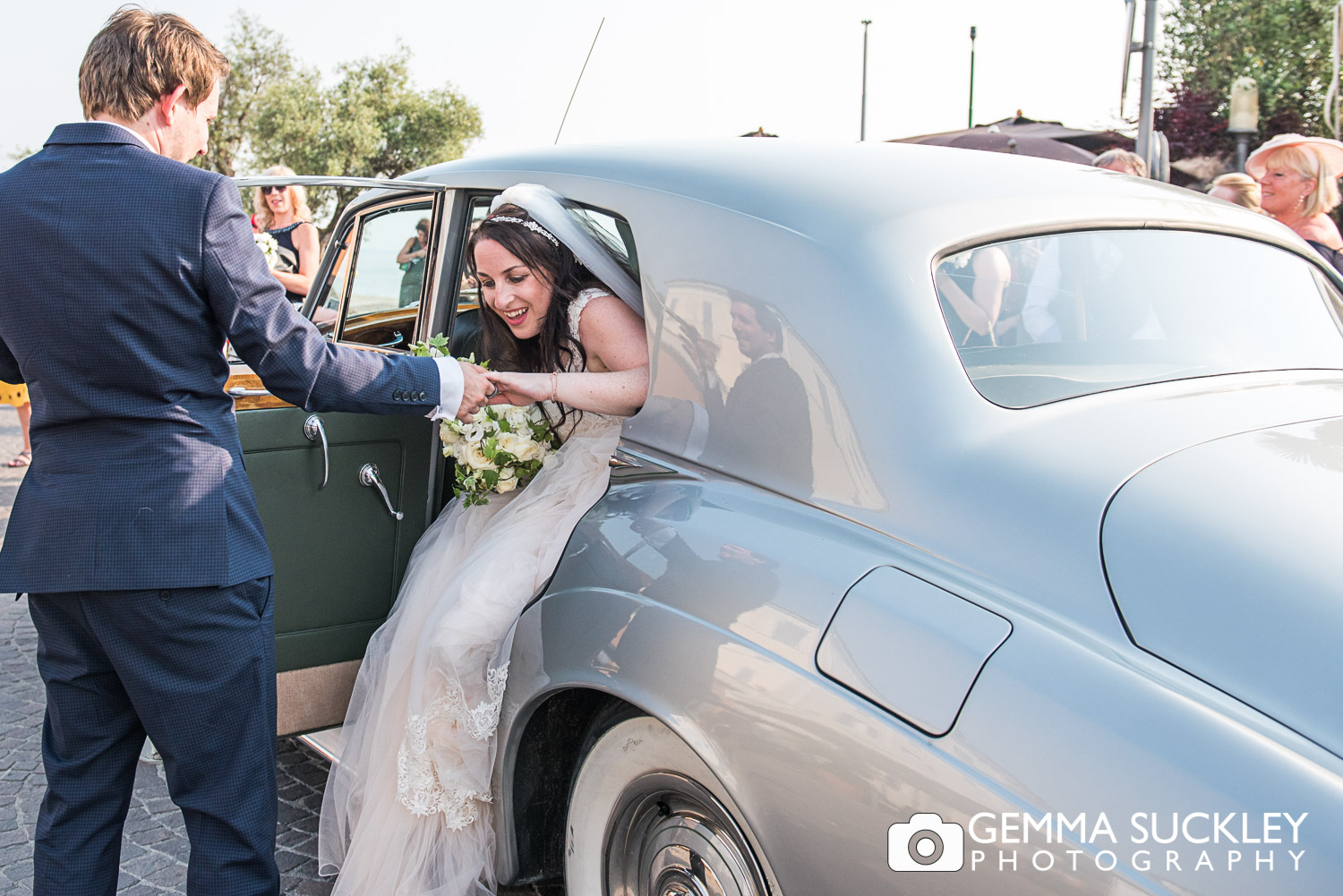 bride and groom getting out of the wedding car