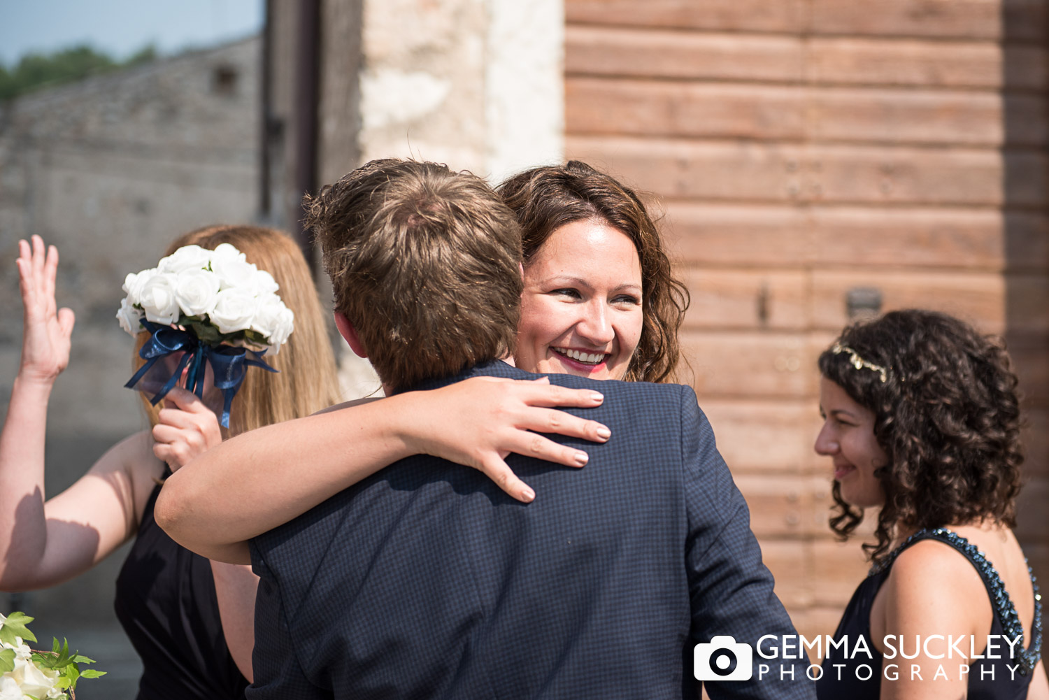 groom hugging wedding guest