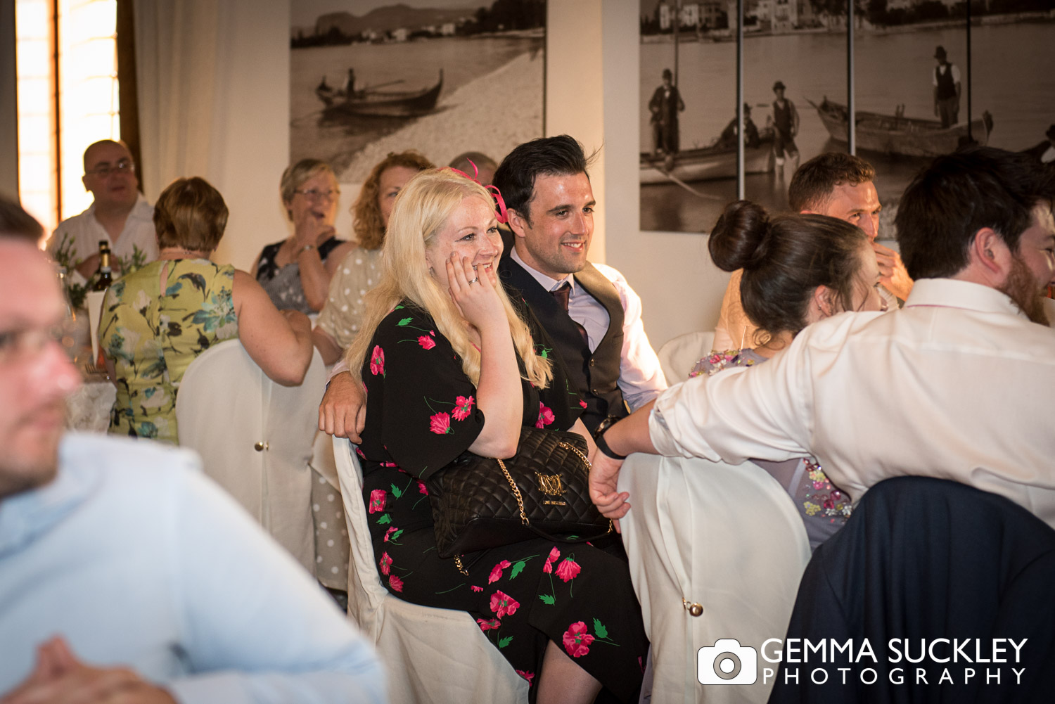 wedding guests laughing during speeches