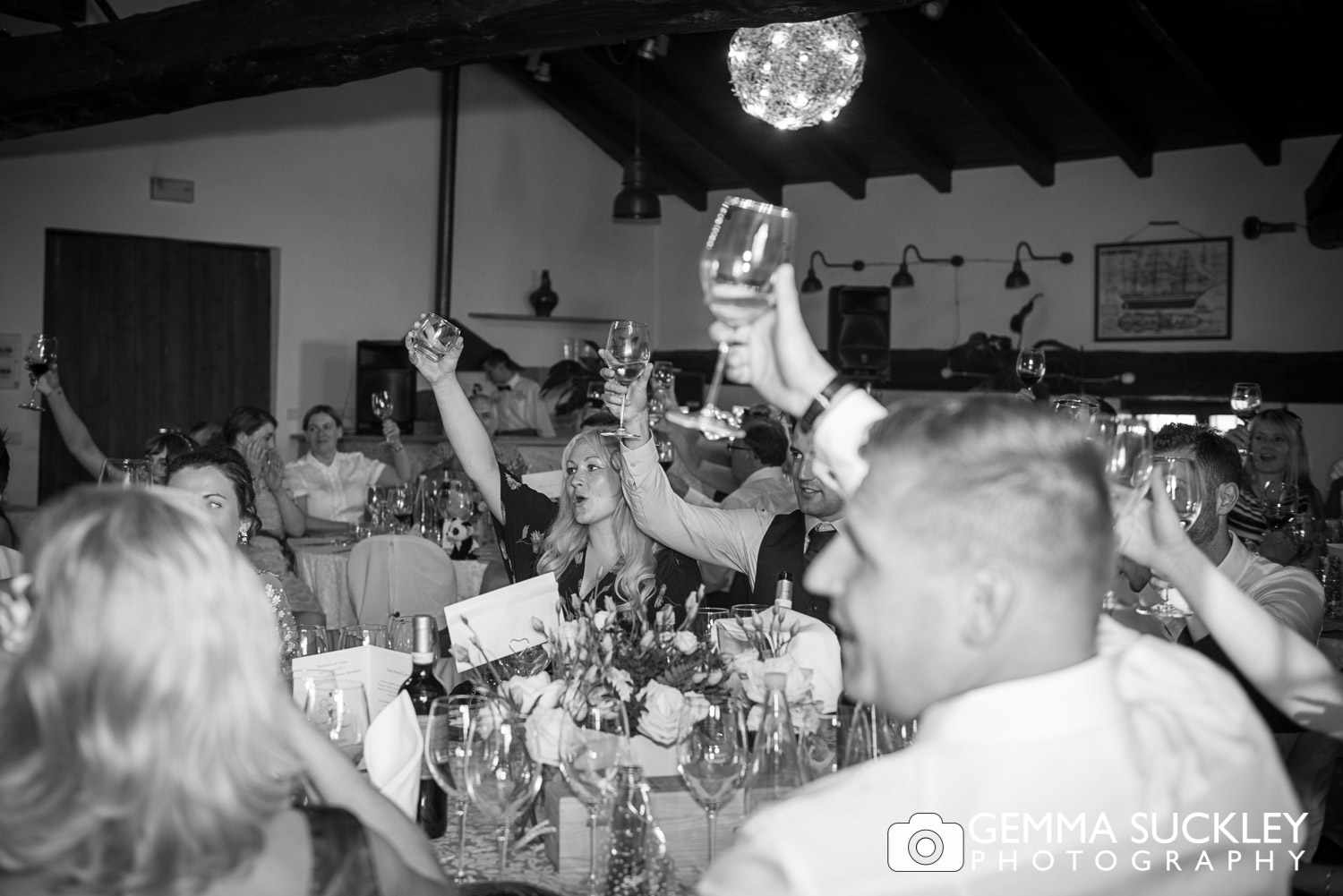 Wedding guest toasting the bride and groom during speeches