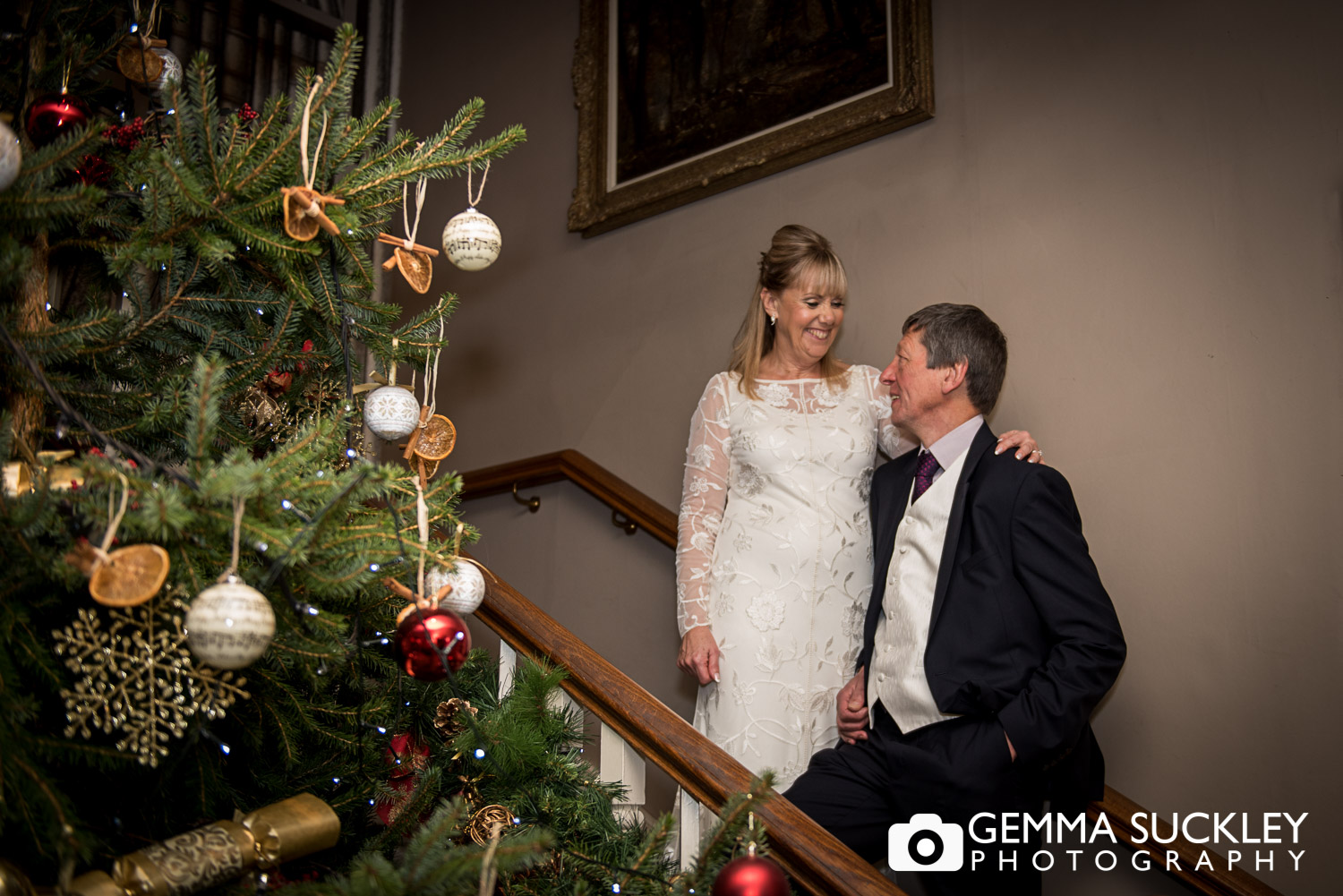 bride and groom stood by a Christmas tree in The Devonshire arms in bolton Abbey