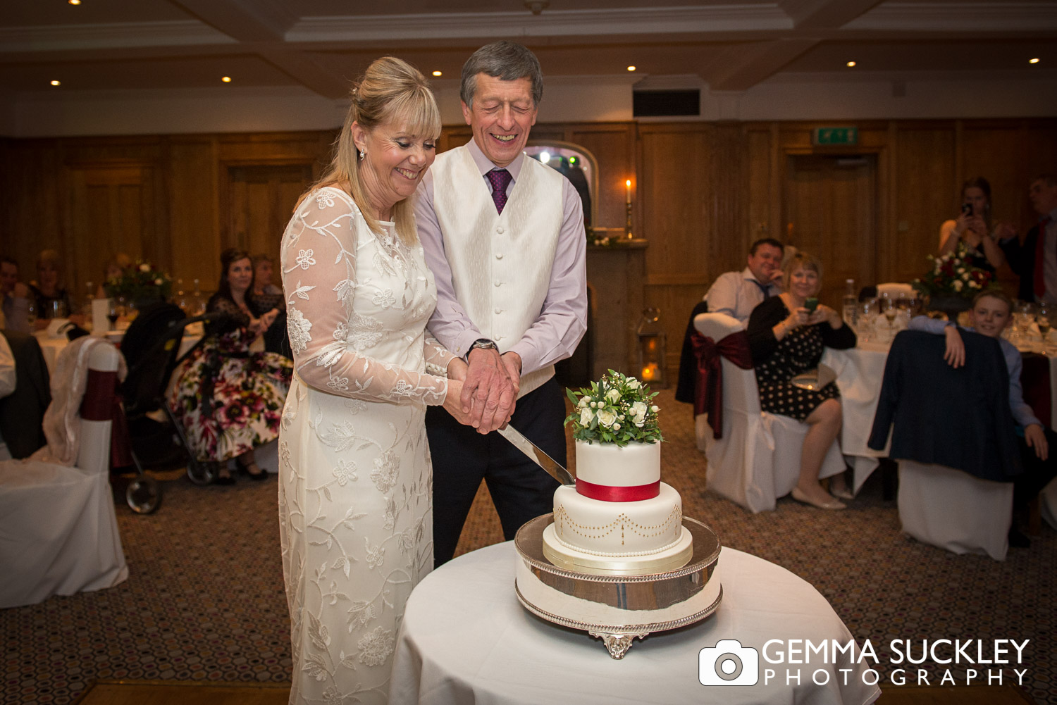 bride and groom cutting the cake wedding cake at Devonshire Arms