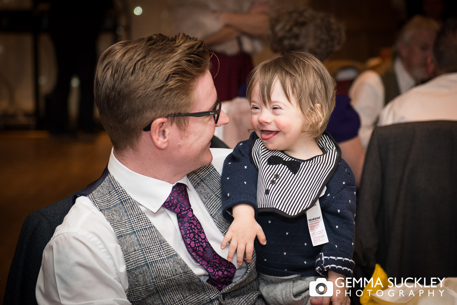 little boy and his dad during wedding speeches