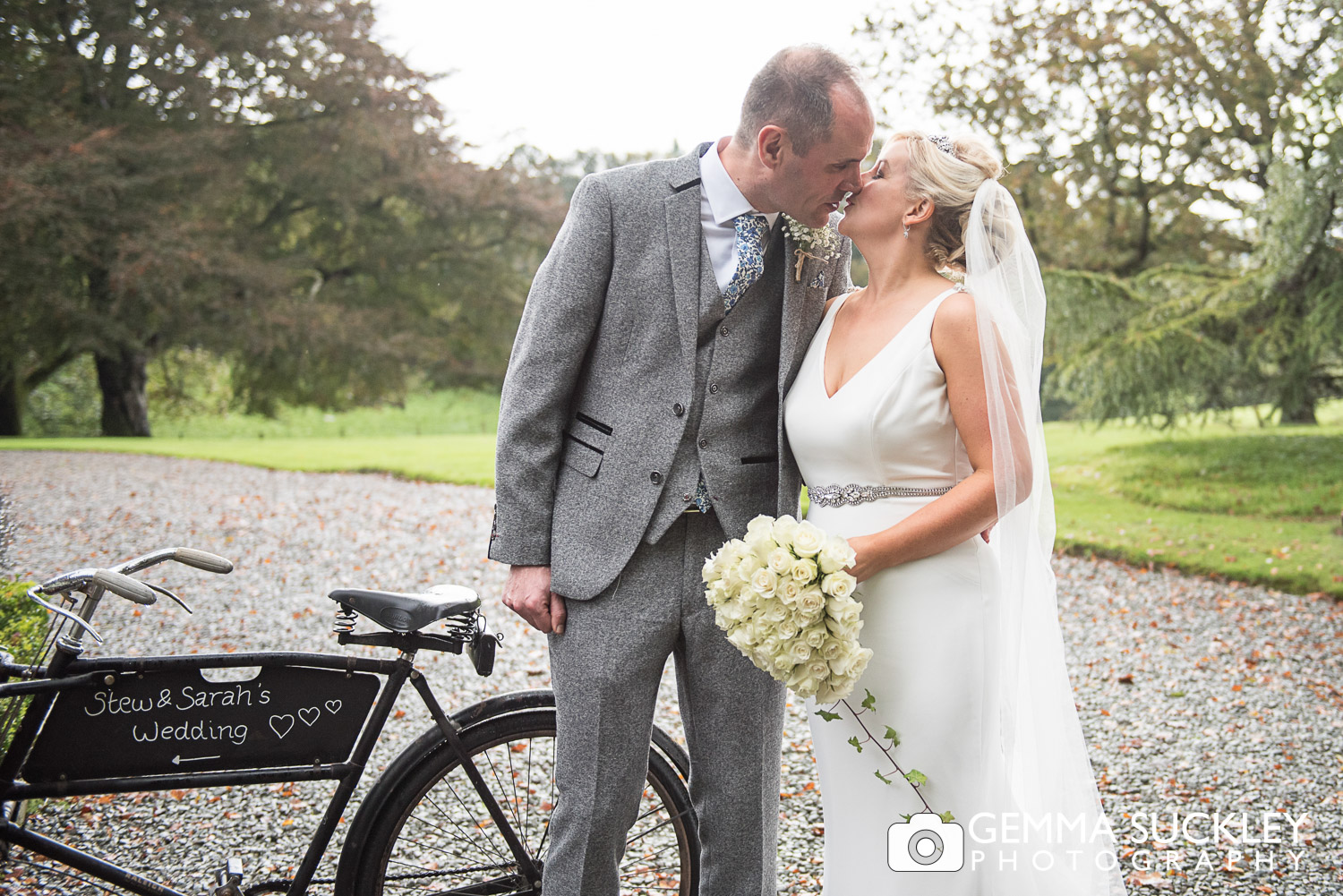 bride and groom kissing outside Belmount Hall