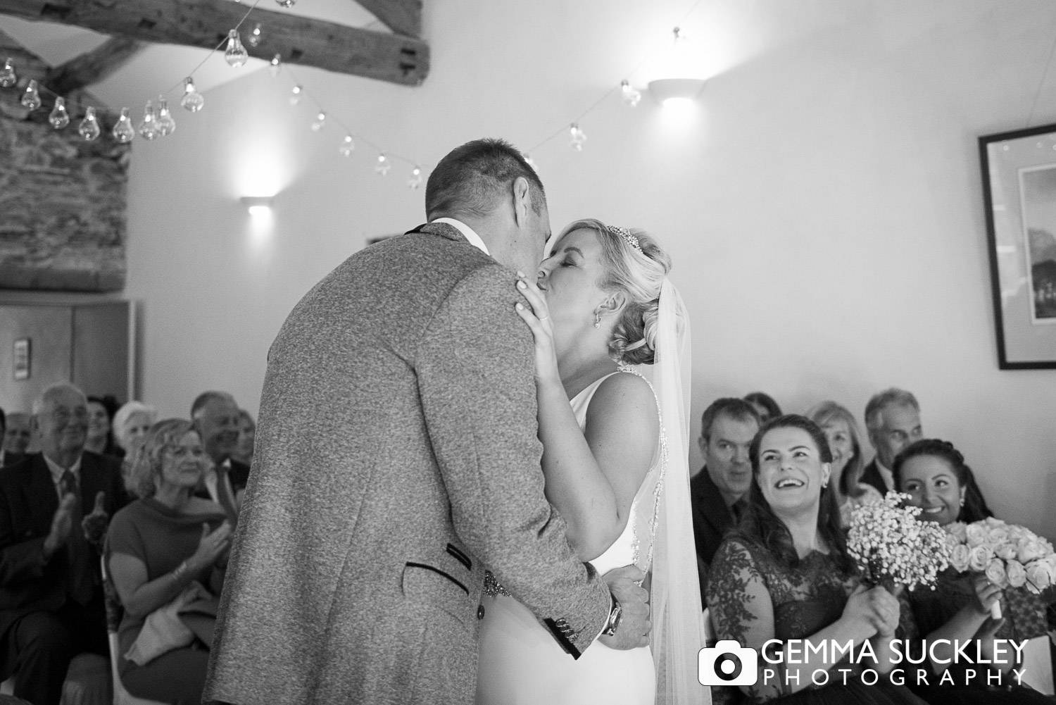 newly-weds kissing after their ceremony at Belmount Hall