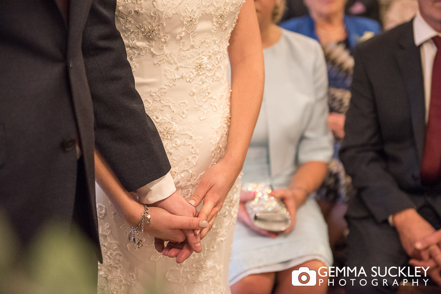 bride and groom holding hands at Grassington House wedding ceremony