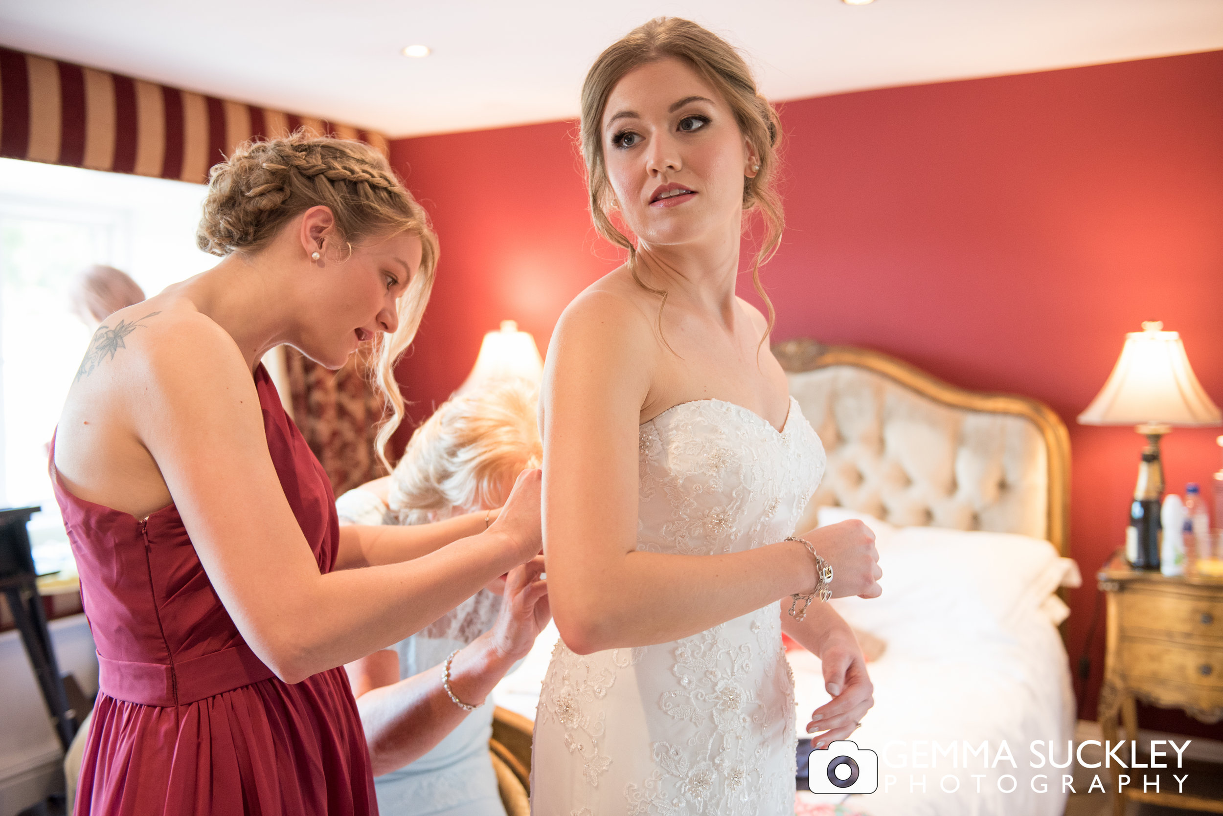 bride getting into her wedding dress