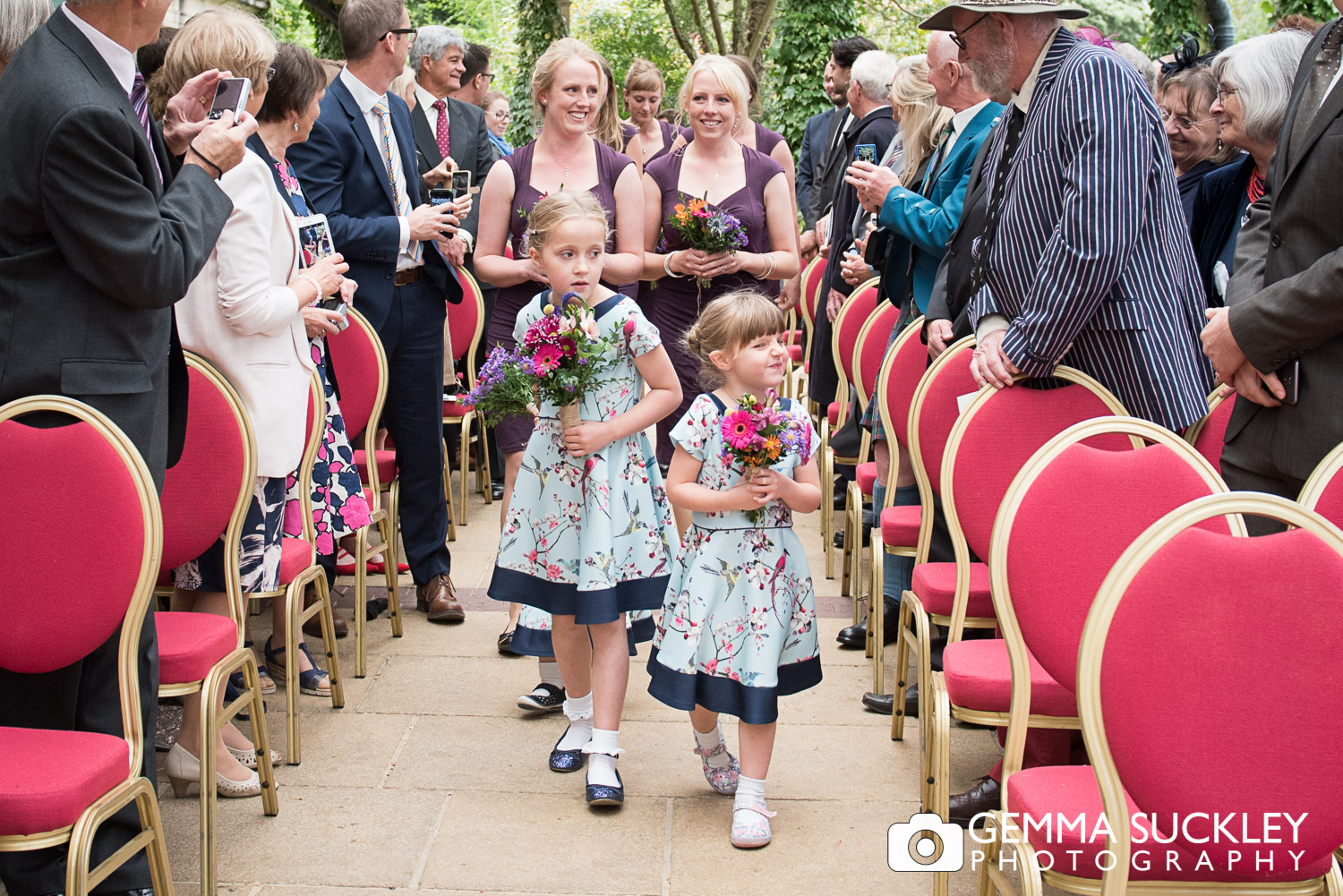 flower girls walking down the aisle at the Sun Pavilion 