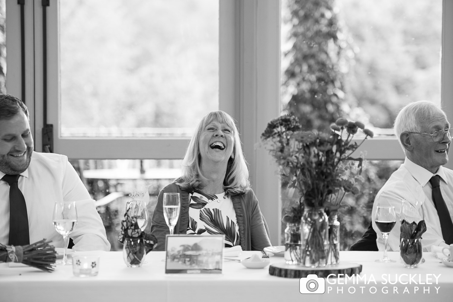 mother of the bride laughing at wedding speeches