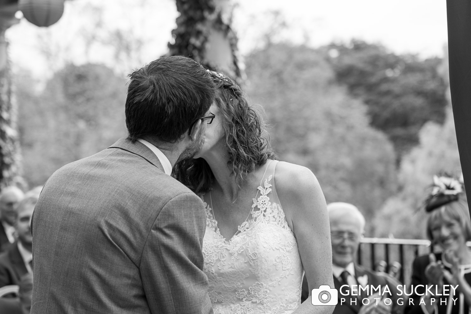 bride and groom kiss after wedding vows at Sun Pavilion