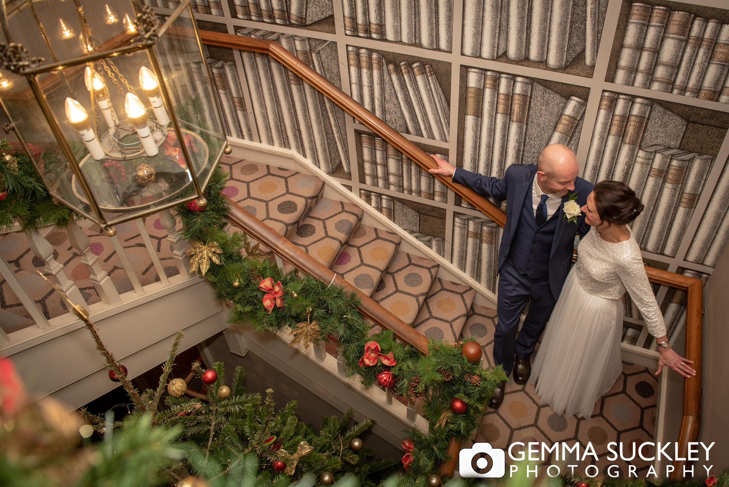 bride and groom on the stairs at the devonshire arms hotel, skipton 