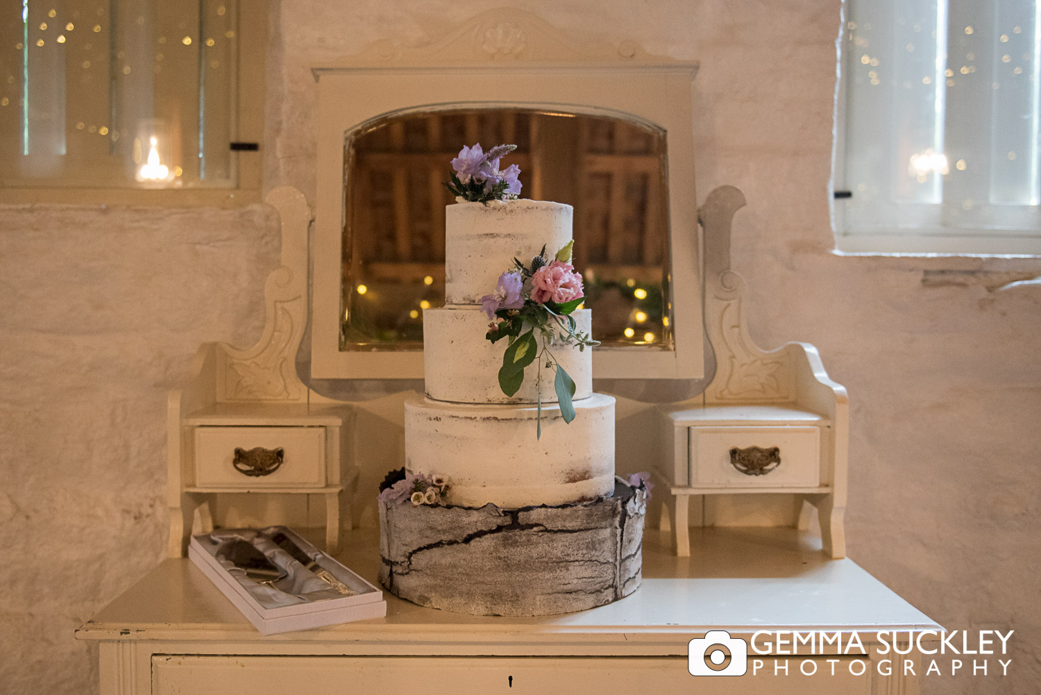 wedding cake on a vintage table in the East riddlesden hall barn
