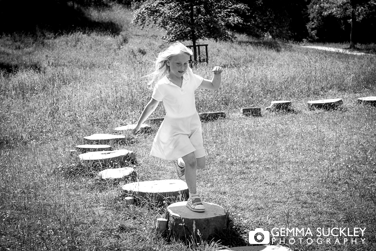 little girl on stepping stones at bolton abbey during their family photo shoot