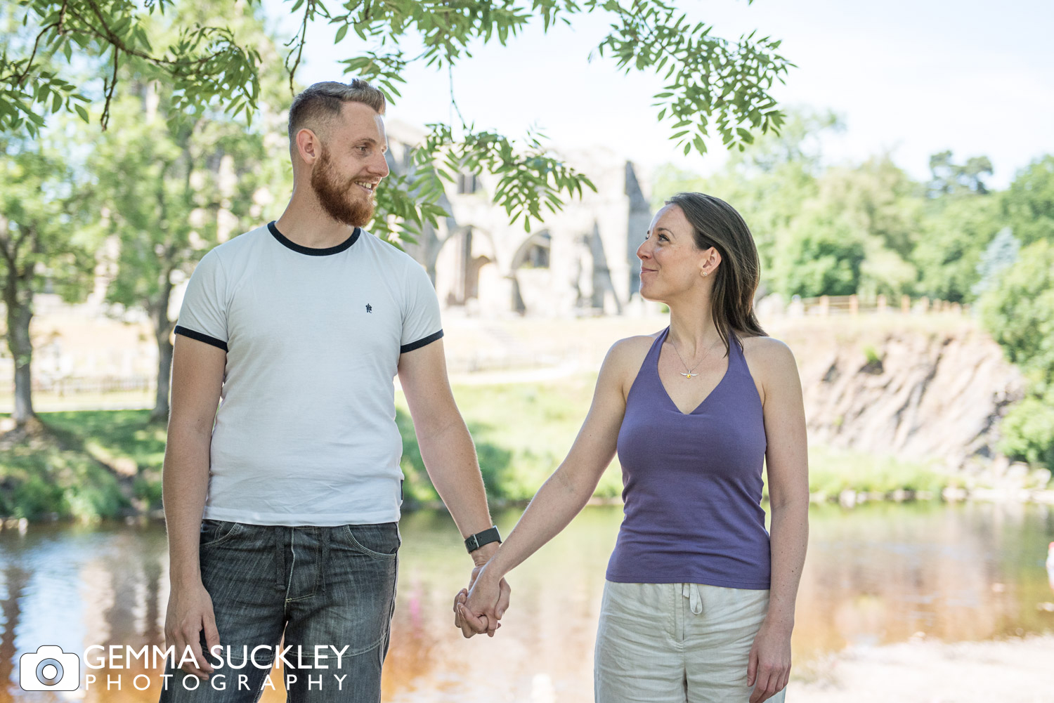 couple holding hands at bolton abbey during a natural family photo shoot