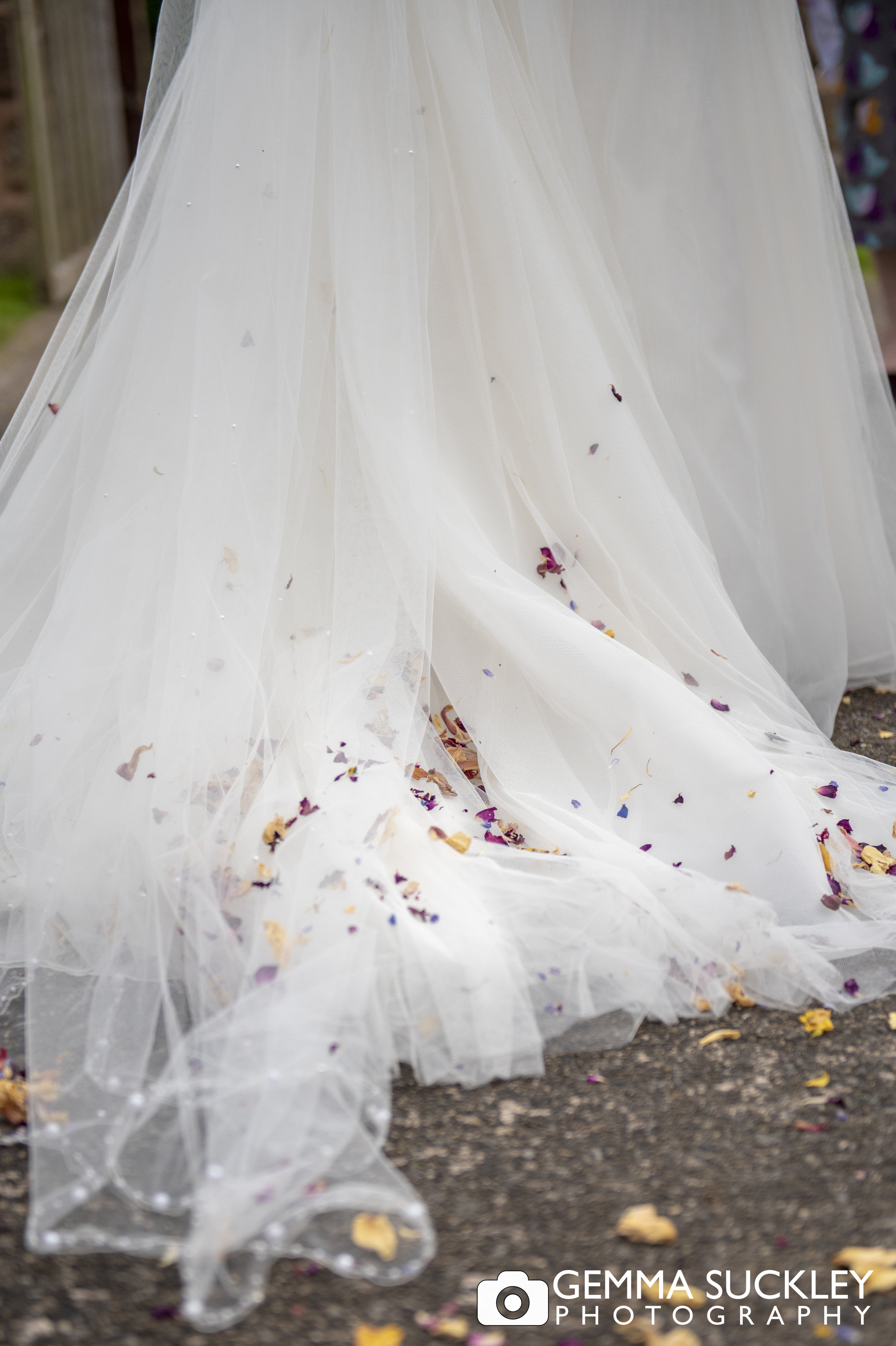 close up photo of confetti on the back of a wedding dress