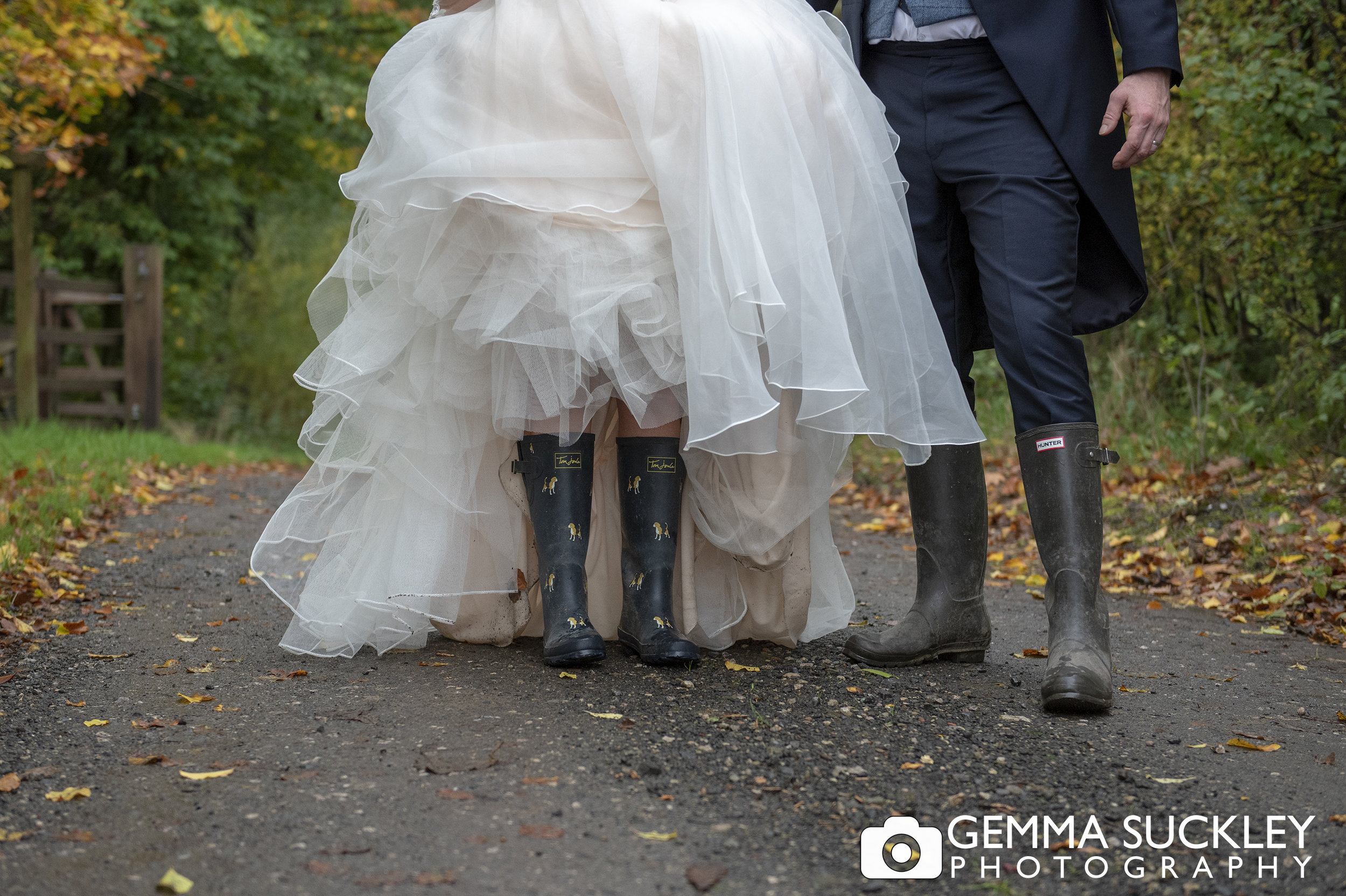 close up wedding photo of bride and groom wellies at the out barn in Clitheroe 