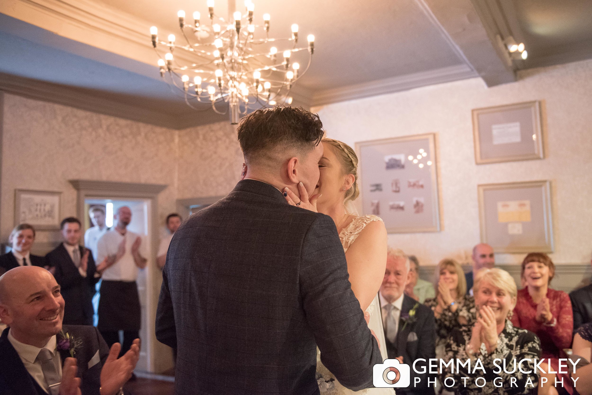 groom kissing his bride at grassington house wedding