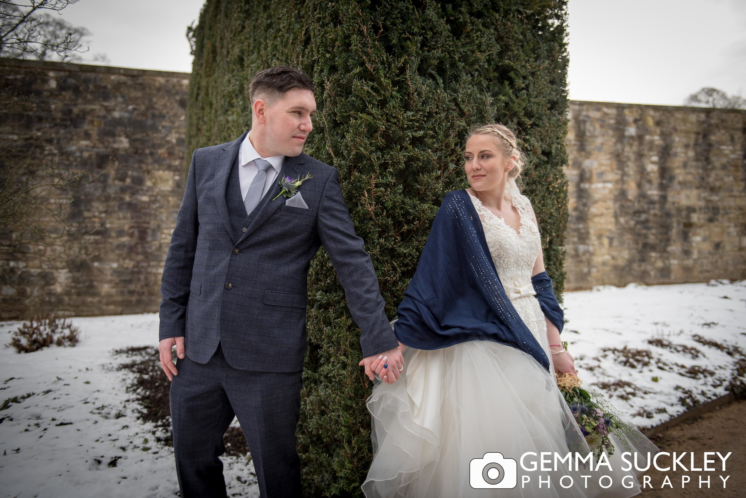 snowy wedding photos of bride and groom at broughton hall