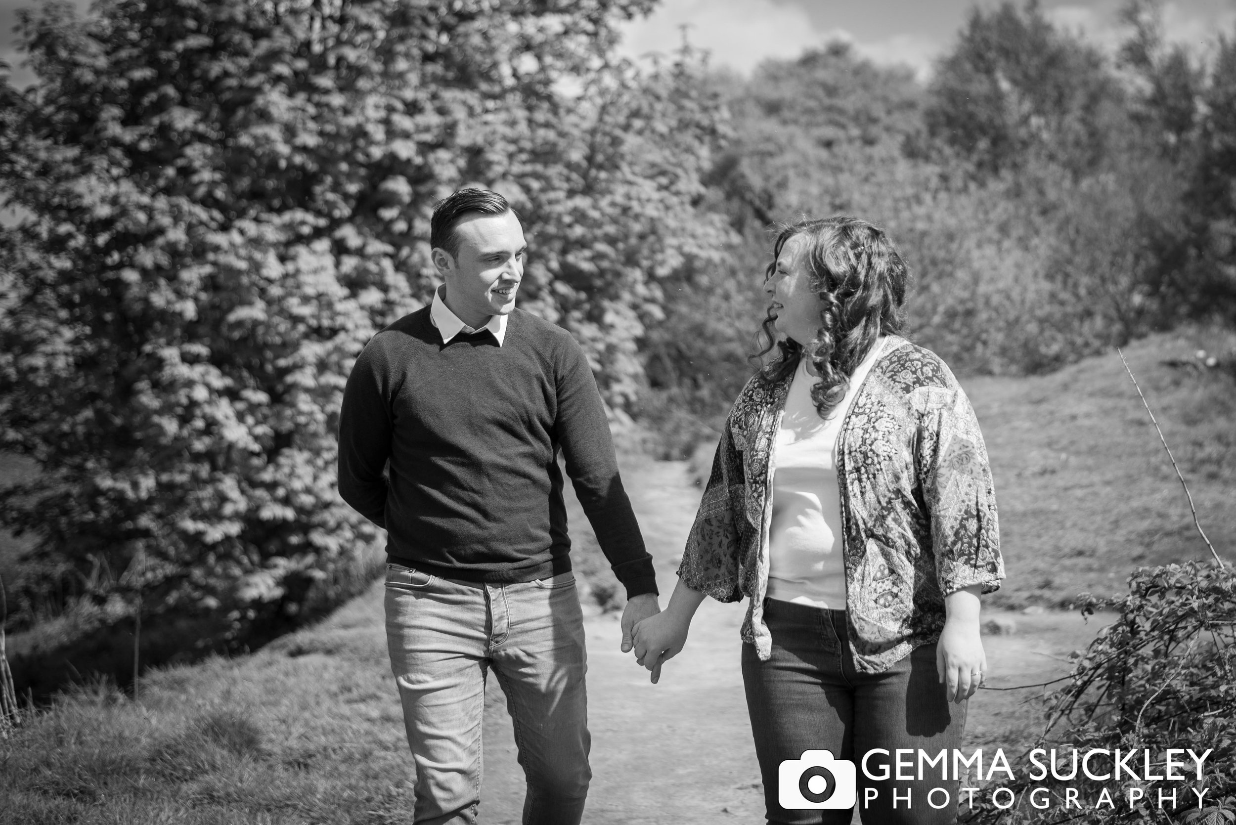 black and white photo of a couple holding hands at the otley chevin