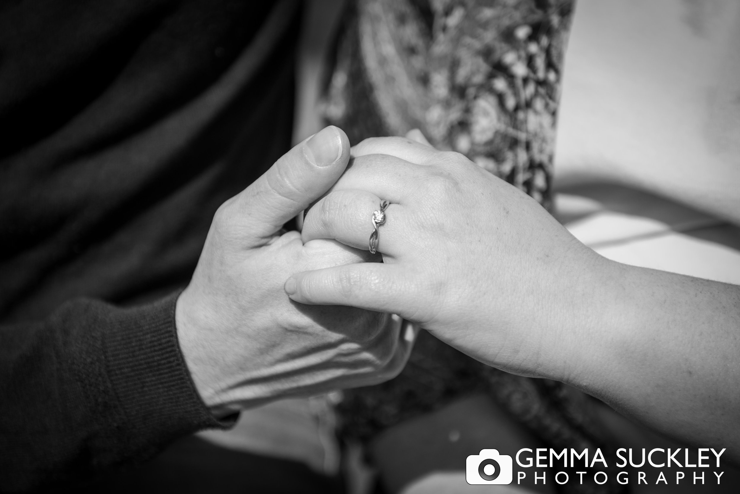 photo of engagement rings couple holding hands