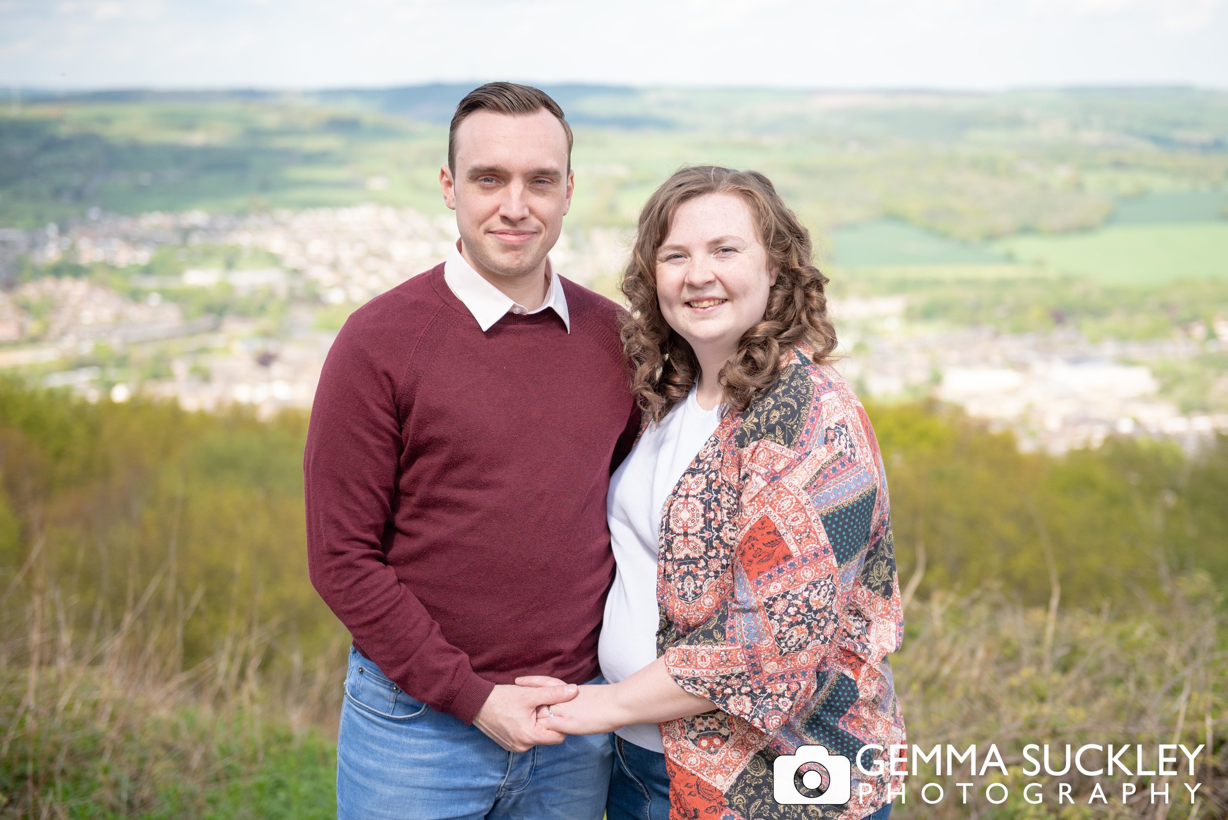 couple holding hands and smiling during their engagement shoot in otley
