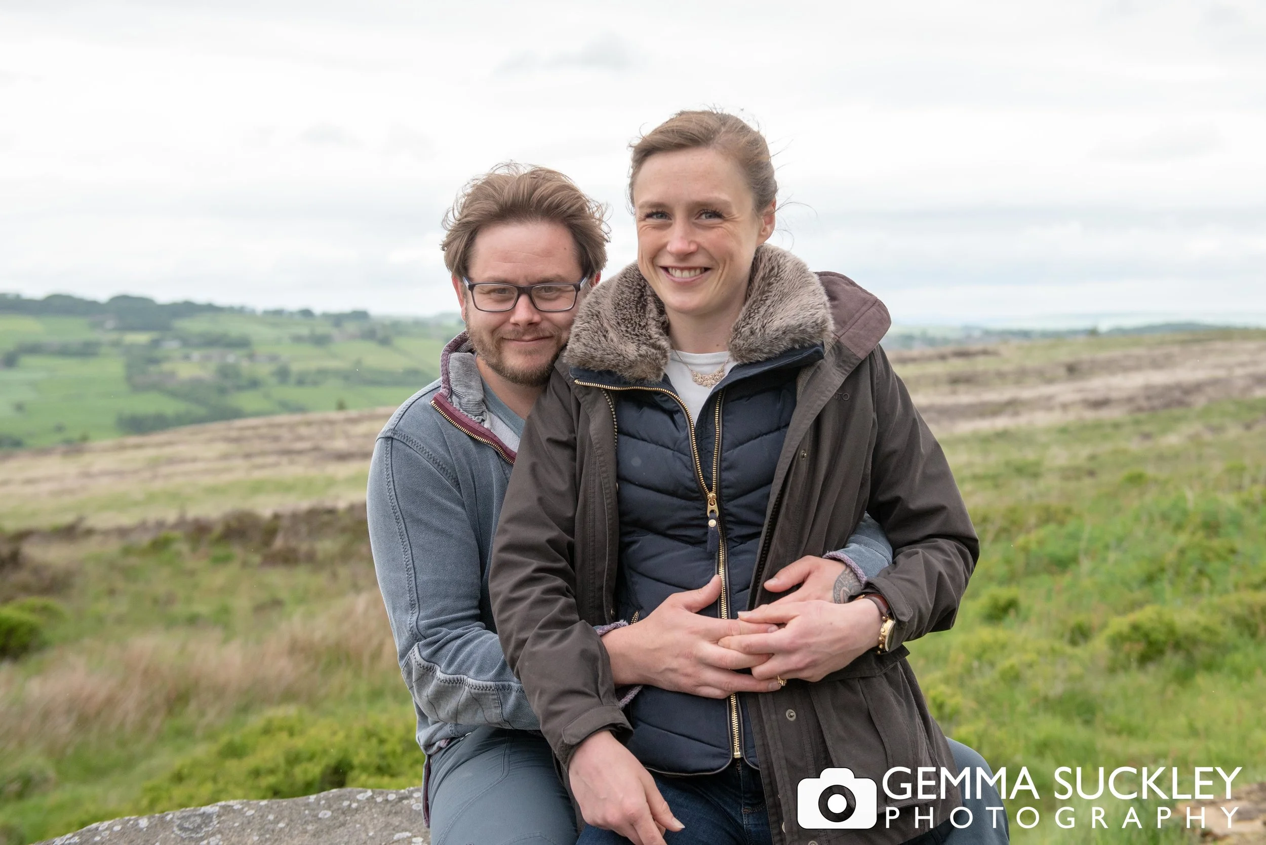 a couple smiling for their wedding wedding photo on haworth moor
