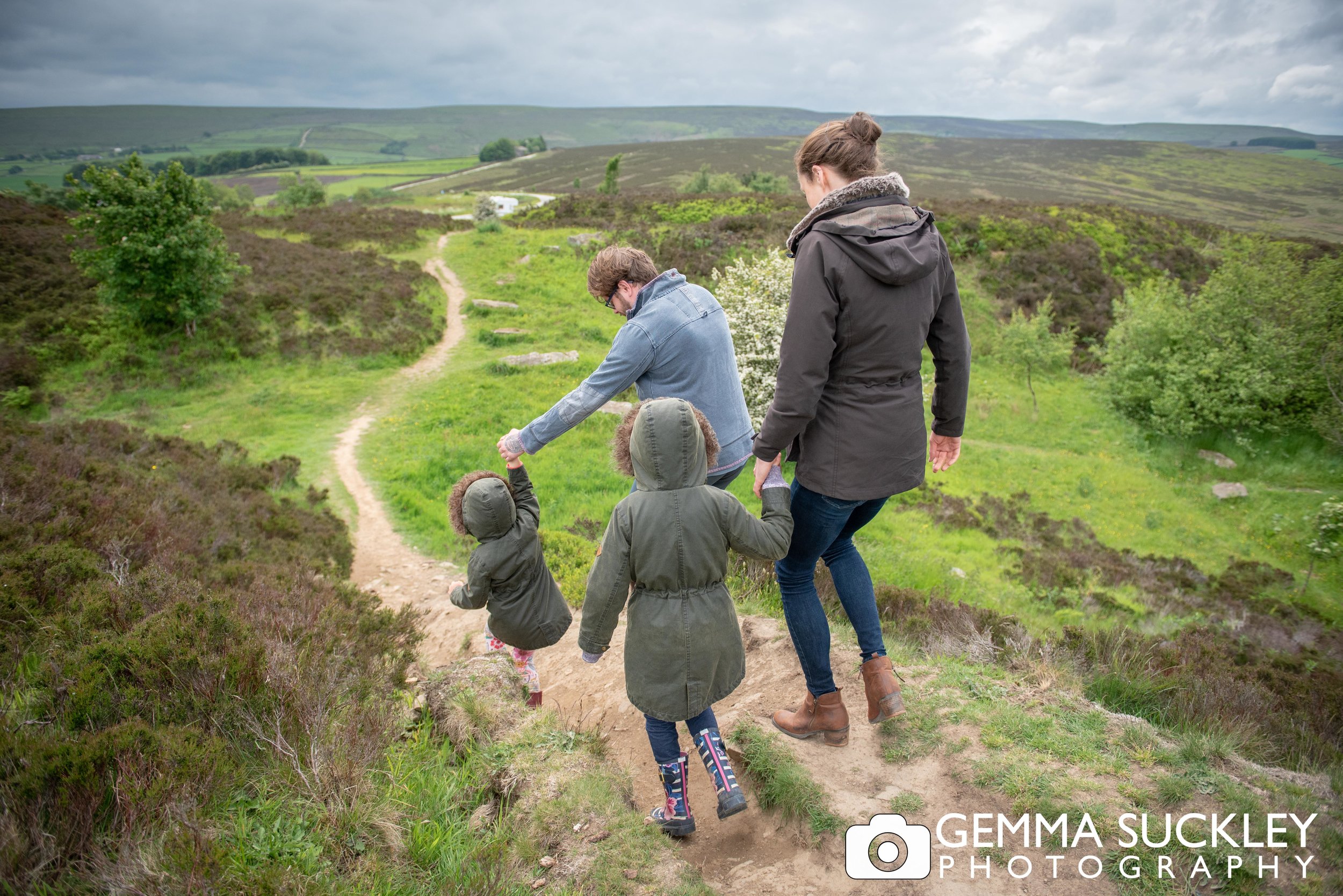 colourful photo of a family walking on haworth moor