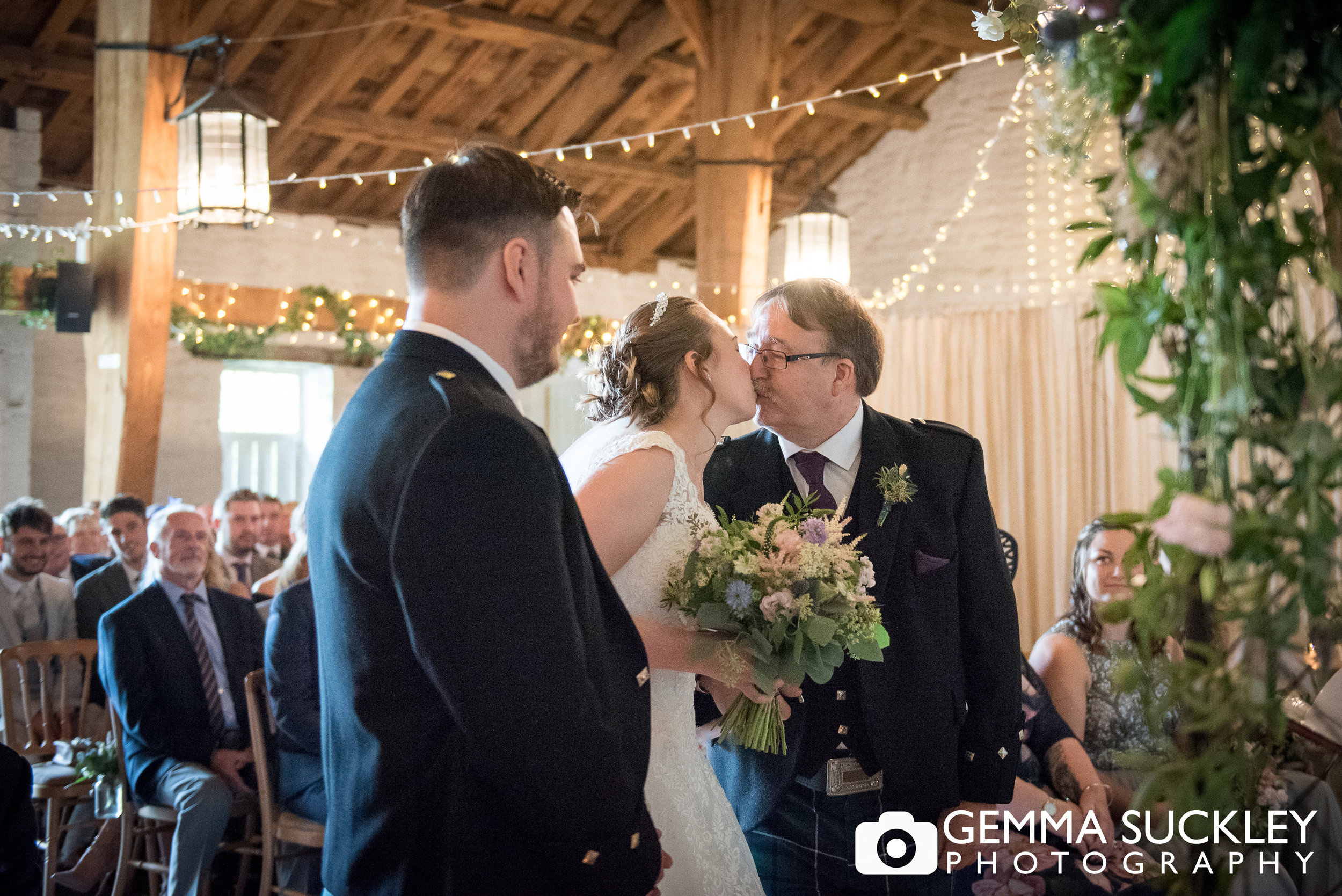 father of the bride kissing his daughter at east riddlesden hall