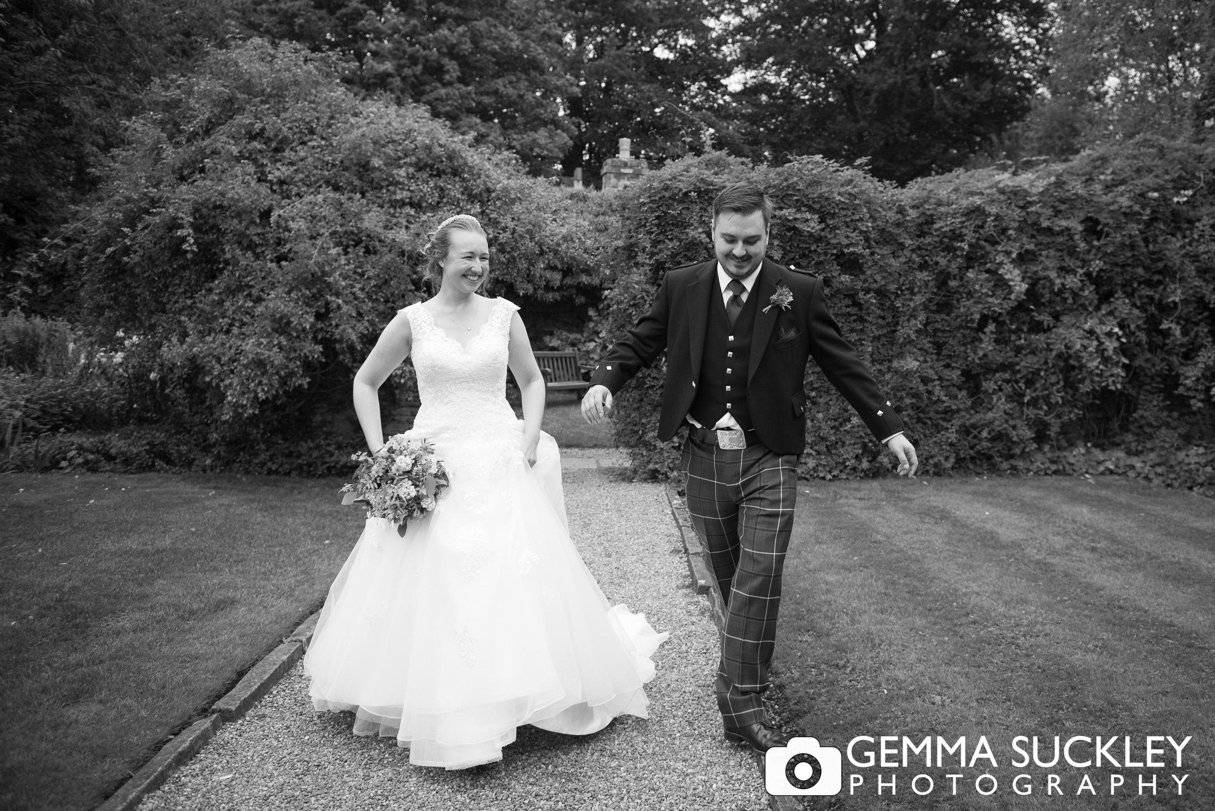 black and white photo of the bride and groom in the gardens of east riddlesden hall