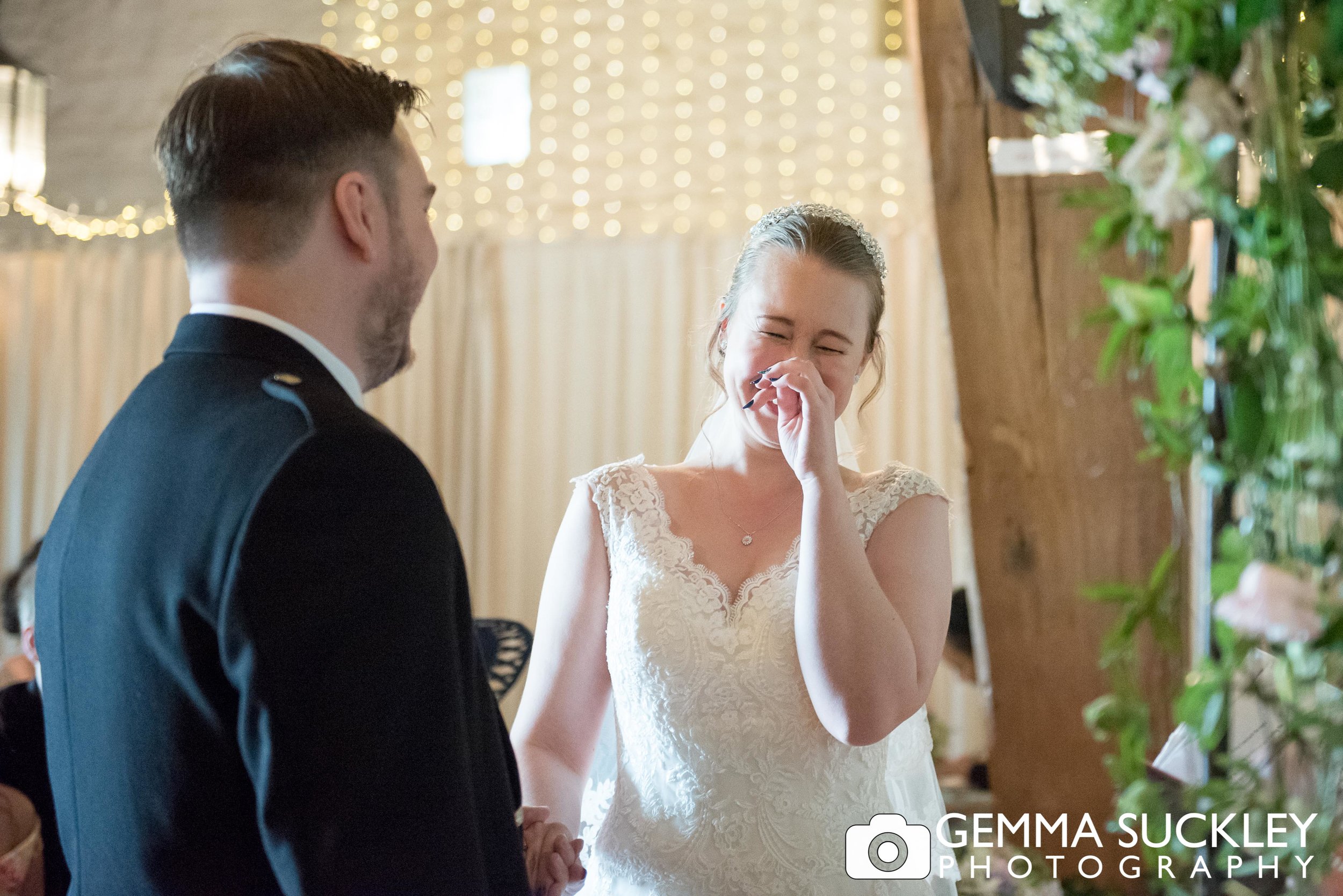 bride laughing during her wedding vows